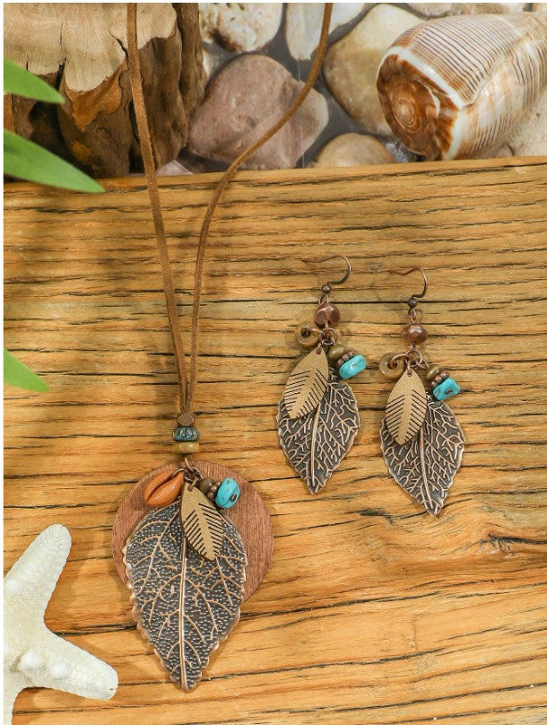 “Boho vintage jewelry set with leaf earrings and turquoise layered necklace”
“Geometric leaf-shaped metal earrings with boho layered pendant necklace”
“Wood bead, shell, and turquoise decor necklace with matching earrings”
“Nature-inspired bohemian jewelry set for women’s daily and festival wear”