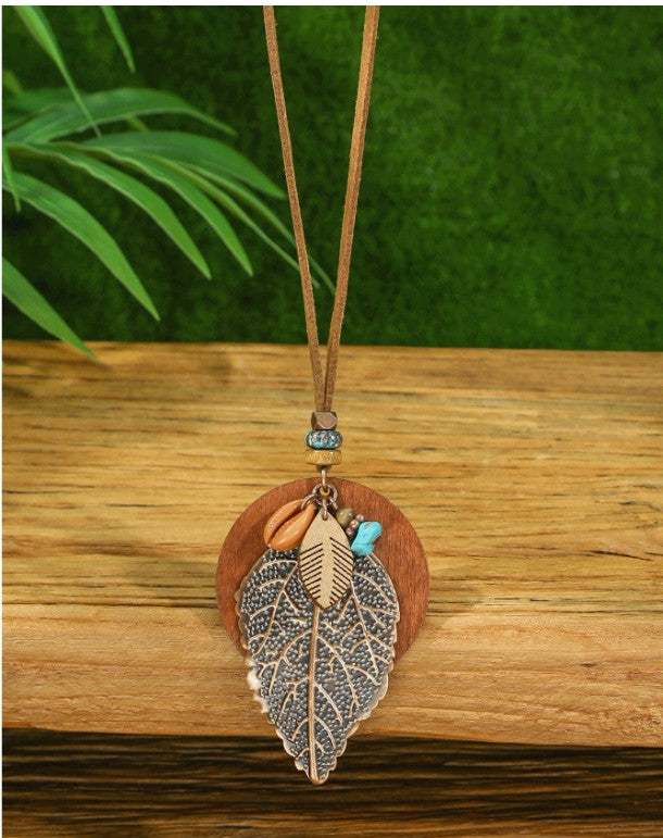 “Boho vintage jewelry set with leaf earrings and turquoise layered necklace”
“Geometric leaf-shaped metal earrings with boho layered pendant necklace”
“Wood bead, shell, and turquoise decor necklace with matching earrings”
“Nature-inspired bohemian jewelry set for women’s daily and festival wear”