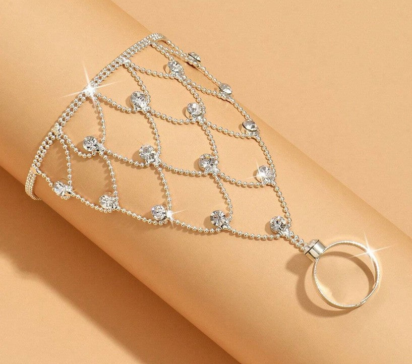 “Tassel and rhinestone hand chain bracelet connecting finger to wrist”
“Shiny finger-to-wrist bracelet with tassels and crystals”
“Boho glam rhinestone hand harness jewelry”
“Festival-style tassel bracelet with finger ring chain”