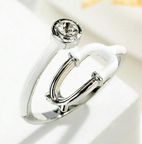 “Adjustable stethoscope-inspired fashion ring for nurses and doctors”
“Silver medical symbol ring for healthcare professionals”
“Heart & Soul Collection stethoscope jewelry piece”
