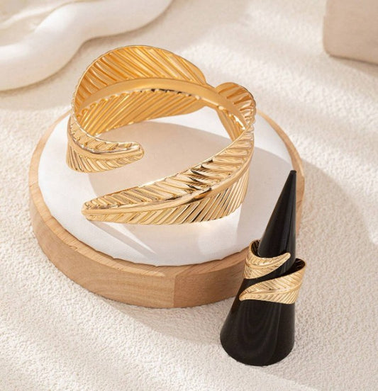 “Leaf-shaped metal bracelet and adjustable ring set for women”

“Boho jewelry set with nature-inspired leaf design”

“Gold-toned adjustable ring and cuff bracelet set for goddess style”

“Fashionable leaf bracelet and open ring gift set for women”