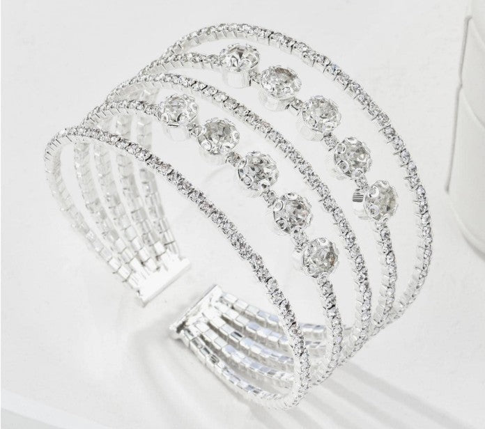 “Five-tier rhinestone cuff bracelet for weddings”

“Elegant open cuff with layered rhinestone bands”

“Bridal rhinestone bracelet with attached five-tier design”

“Glamorous bridal cuff with multi-layer sparkle”