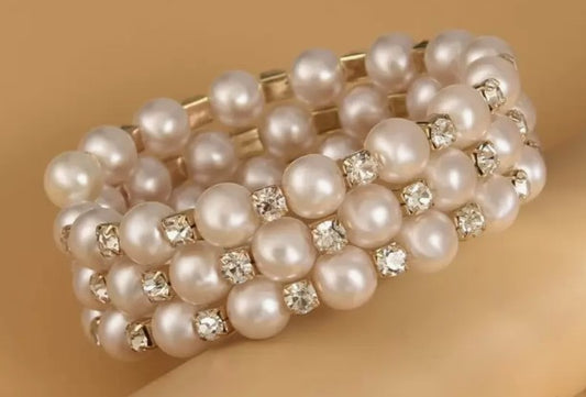“Triple-layer gold, rhinestone, and faux pearl bangle bracelet”

“Elegant stacked bracelet with pearls and sparkle”

“Layered women’s bangle with gold tone, rhinestones, and pearls”

“3-in-1 spiritual bangle for bridesmaids or special occasions”