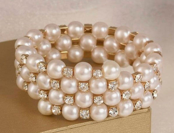 “Triple-layer gold, rhinestone, and faux pearl bangle bracelet”

“Elegant stacked bracelet with pearls and sparkle”

“Layered women’s bangle with gold tone, rhinestones, and pearls”

“3-in-1 spiritual bangle for bridesmaids or special occasions”
