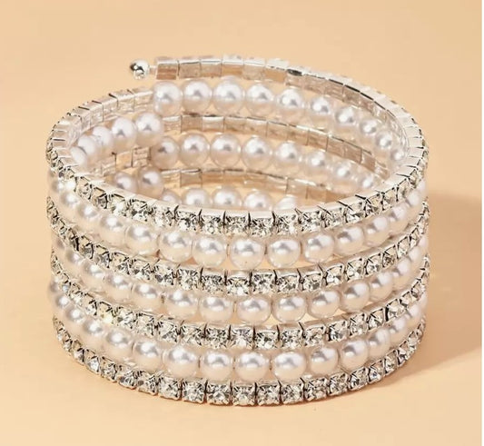“7-tier silver-tone bracelet with rhinestones and faux pearls”

“Elegant silver bangle with layered pearl and rhinestone design”

“Silver stacked bracelet for weddings and spiritual occasions”

“ silver rhinestone and faux pearl bangle bracelet”