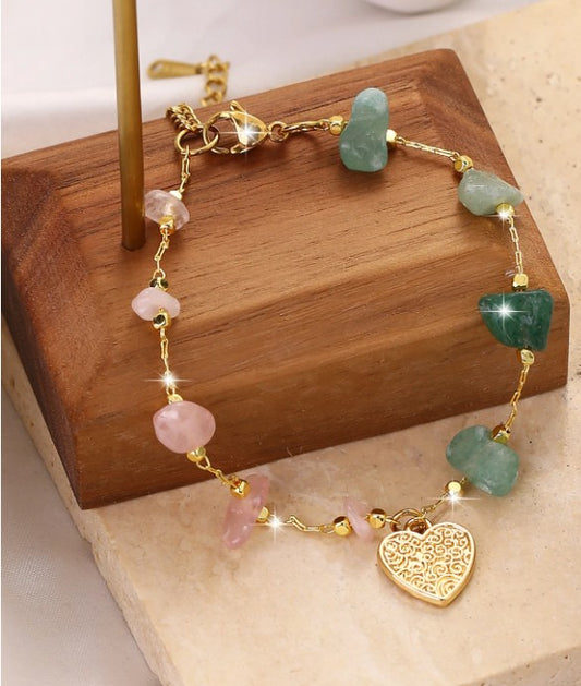 “Bohemian pink and green stone bracelet with heart charm”

“Gold-tone single-layer bracelet with natural stones”

“Spiritual heart charm bracelet for women”

“Nature-inspired gold bracelet with pink and green stones”

“Lightweight bohemian bracelet Christie Bella Gifts”

