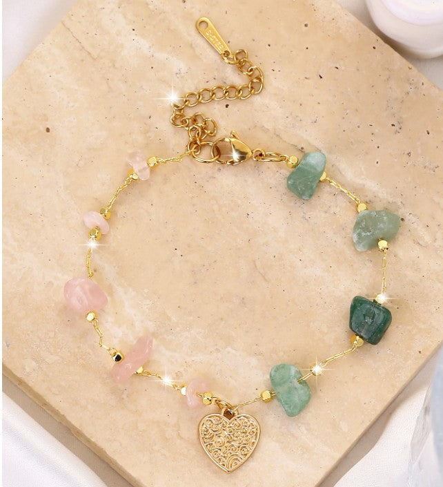 “Bohemian pink and green stone bracelet with heart charm”

“Gold-tone single-layer bracelet with natural stones”

“Spiritual heart charm bracelet for women”

“Nature-inspired gold bracelet with pink and green stones”

“Lightweight bohemian bracelet Christie Bella Gifts”

