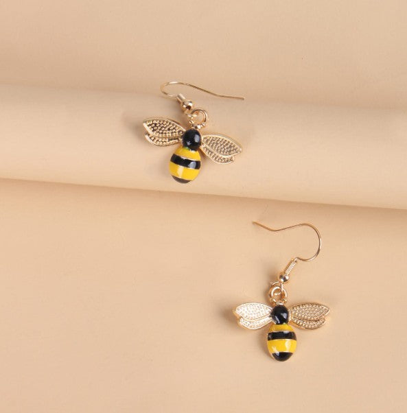 “Gold-tone dangling bee earrings with hook backs, 1.5 inch drop”

“Lightweight nature-inspired bee earrings for women”

“Dangling bee charm earrings from Christie Bella Bee Loved Collection”

“Boho bee drop earrings with spiritual symbolism”