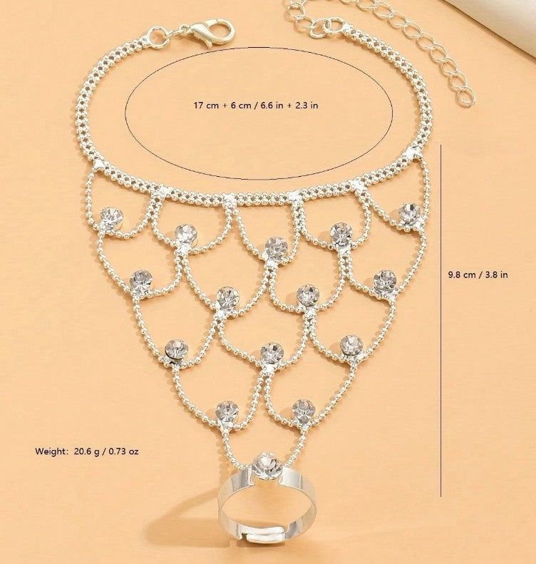 “Tassel and rhinestone hand chain bracelet connecting finger to wrist”

“Shiny finger-to-wrist bracelet with tassels and crystals”

“Boho glam rhinestone hand harness jewelry”

“Festival-style tassel bracelet with finger ring chain”

